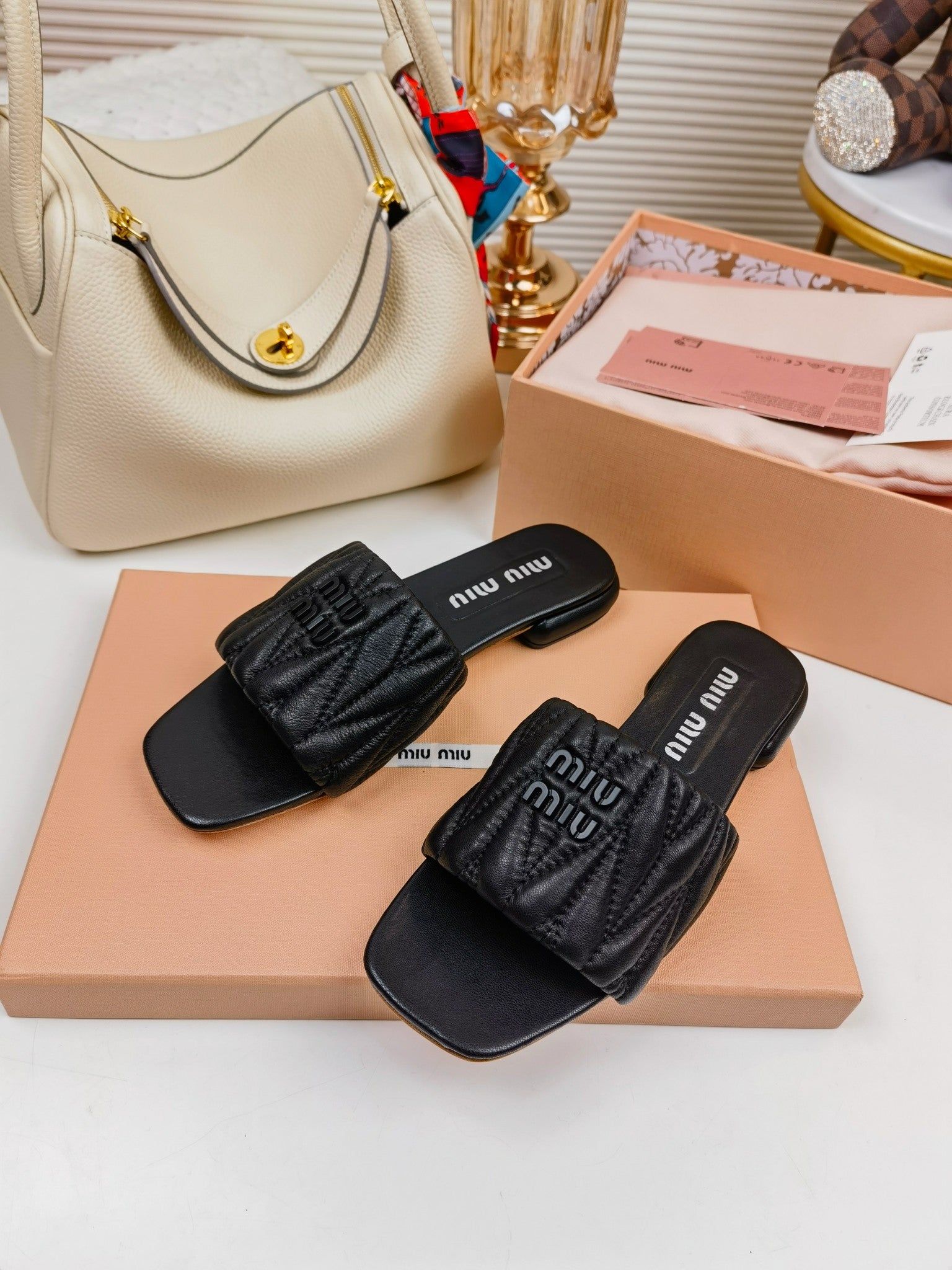 Black MM matelassé leather slides