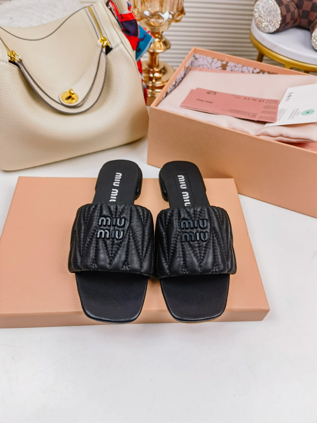 Black MM matelassé leather slides