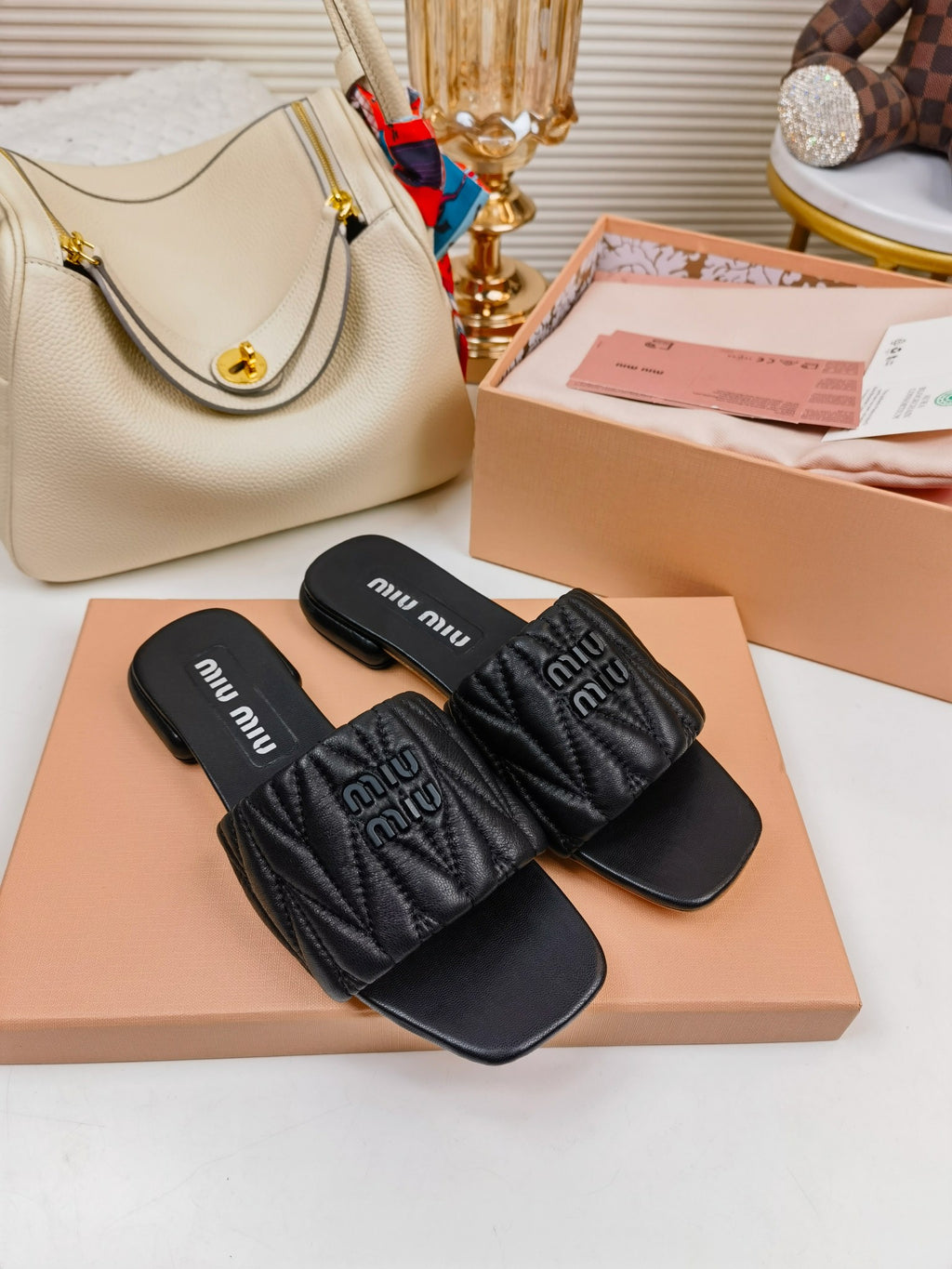 Black MM matelassé leather slides