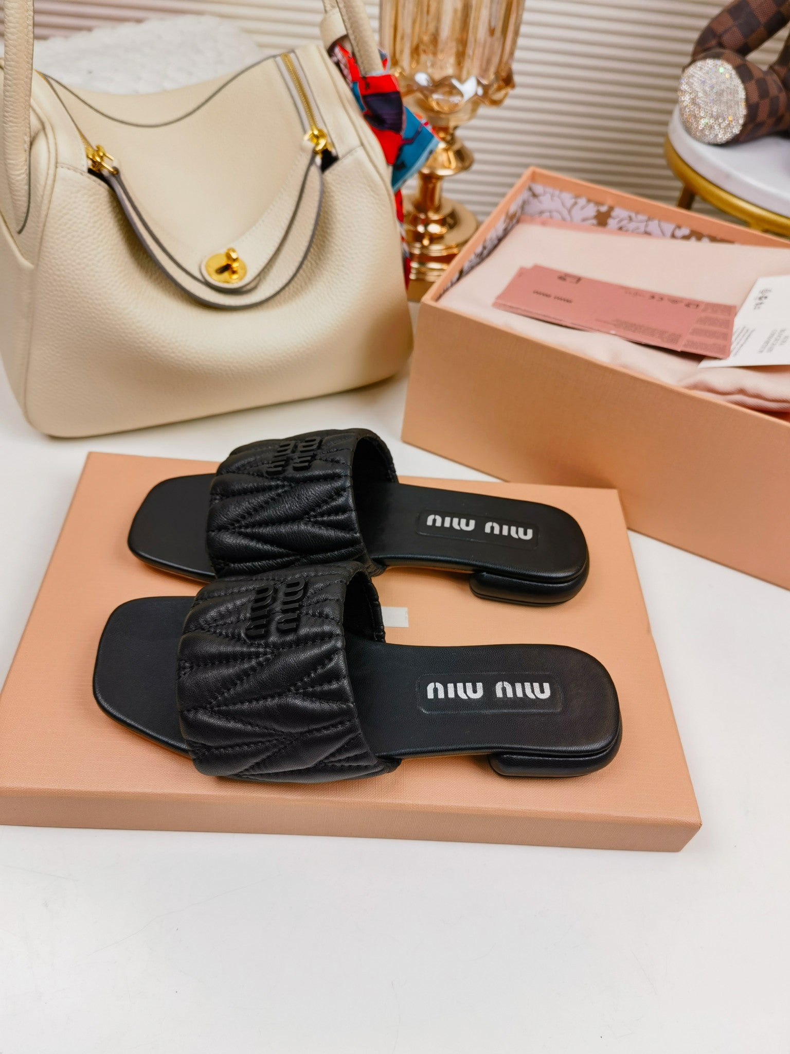 Black MM matelassé leather slides