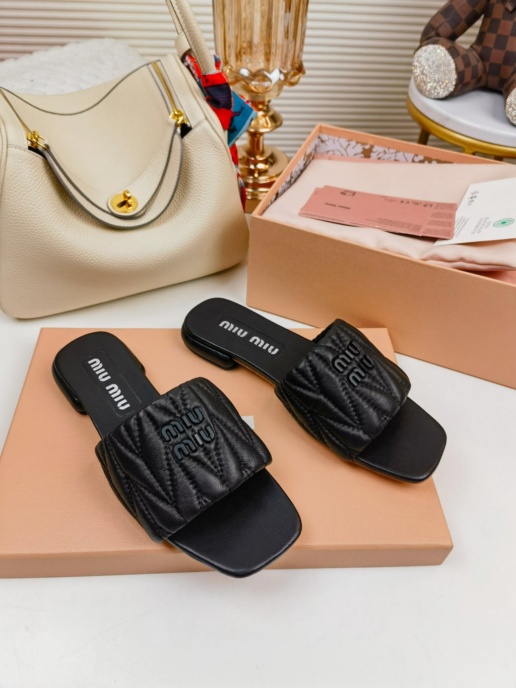 Black MM matelassé leather slides