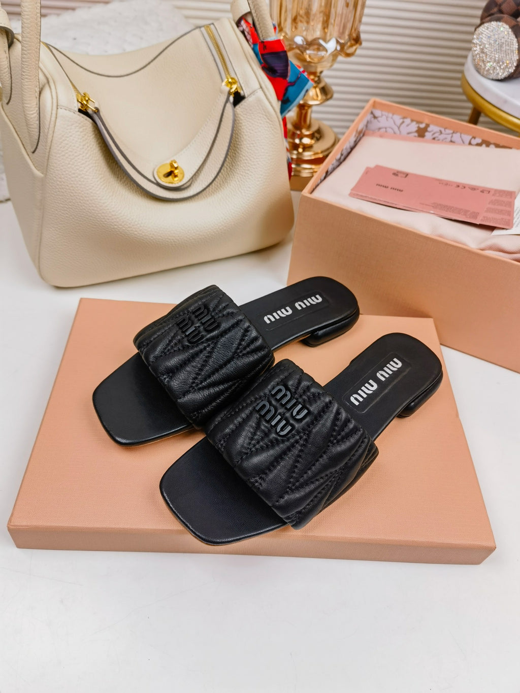 Black MM matelassé leather slides